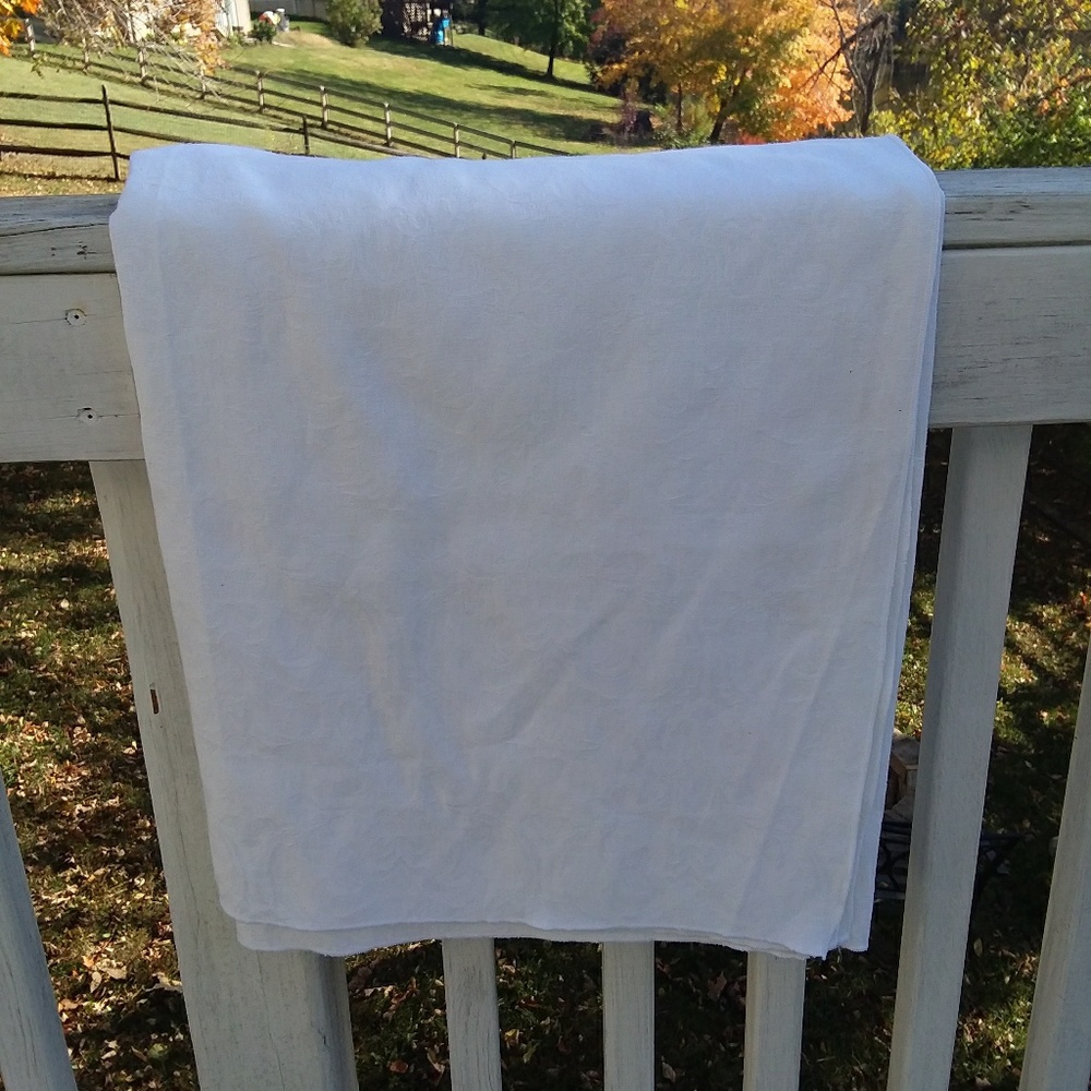 White tablecloth with subtle white foliage pattern